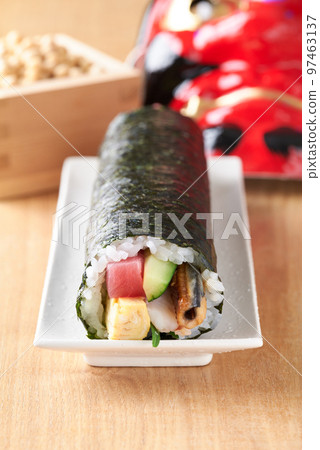 Eho-maki served on a plate (Ingredients: tuna, boiled conger eel, cucumber, omelet, perilla, shrimp.) 97463137