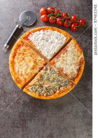 Quattro formaggi Italian pizza topped with a combination of four kinds of cheese such as mozzarella, Gorgonzola, ricotta, and Parmesan closeup Vertical top view 97463348