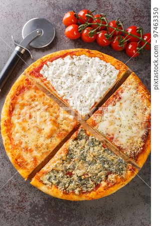 Sliced hot pizza four cheeses close-up on a wooden board. Vertical top view Sliced hot pizza four cheeses close-up on a wooden board. Vertical top view 97463350