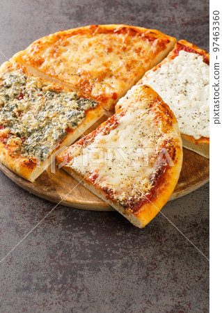 Quattro formaggi Italian pizza topped with a combination of four kinds of cheese such as mozzarella, Gorgonzola, ricotta, and Parmesan closeup Vertical 97463360