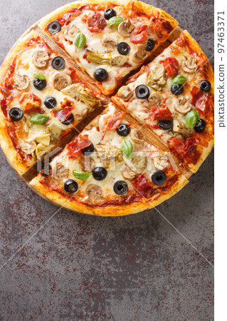 Fresh Homemade Italian Pizza capricciosa with Tomato sauce, mozzarella cheese, ham, mushroom, black olives, artichokes closeup Vertical top view 97463371