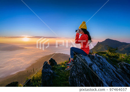 Tourist taking photo at Doi pha tang mountains, Chiang Rai, Thailand. 97464037