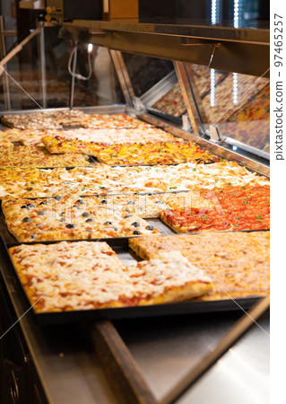 Sale of cut pizza from an Italian pizzeria 97465257