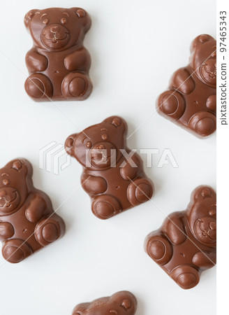 Chocolate teddy bear on a white background. Charming chocolate and delicious gift. Chocolate teddy bear on a white background. Charming chocolate and delicious gift. 97465343