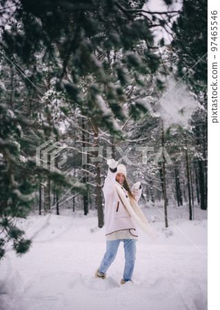 Active beautiful young woman throwing snowball, snowy winter forest Active beautiful young woman throwing snowball, snowy winter forest 97465546