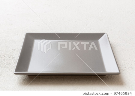 Perspective view of empty square plate on cement background. Empty space for your design Perspective view of empty square plate on cement background. Empty space for your design 97465984