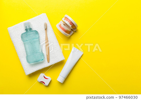 Mouthwash and other oral hygiene products on colored table top view with copy space. Flat lay. Dental hygiene. Oral care kit. Dentist concept 97466030