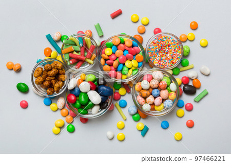 different colored round candy in bowl and jars. Top view of large variety sweets and candies with copy space 97466221
