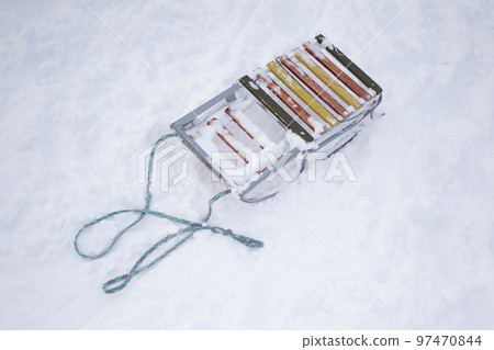 Old sled with a rope on the snow top view. Old sled with a rope on the snow top view. 97470844