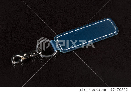 Leather keychain on a dark background. 97470892