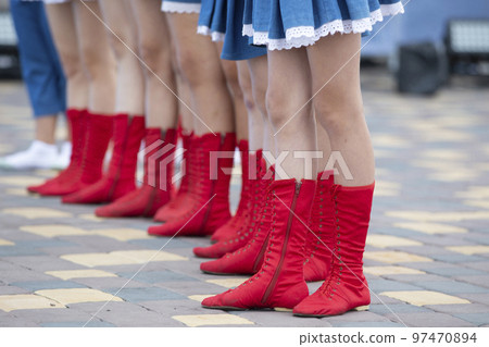 Lots of female legs in red dancing boots. Dance shoes. 97470894