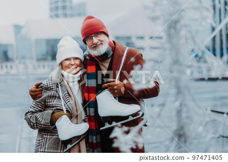 Portrait of seniors in winter at outdoor ice skating rink. Portrait of seniors in winter at outdoor ice skating rink. 97471405
