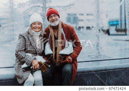 Portrait of seniors in winter at outdoor ice skating rink. Portrait of seniors in winter at outdoor ice skating rink. 97471424
