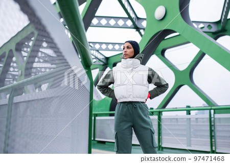 Young muslim woman resting after jogging, outdoor in city. Young muslim woman resting after jogging, outdoor in city. 97471468