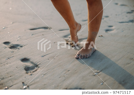 Close-up of childs feet in sand, at sea. Close-up of childs feet in sand, at sea. 97471517
