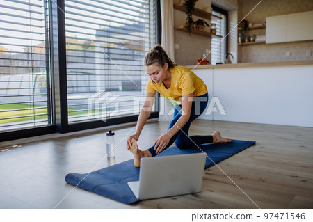 Young woman doing an exercises at home. 97471546