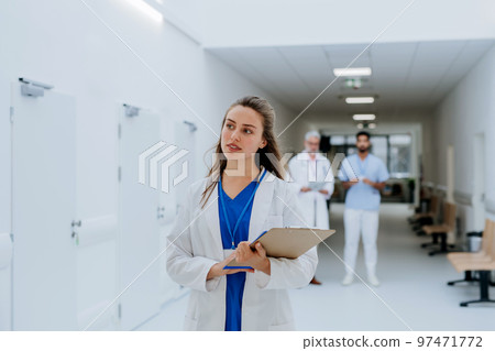 Portrait of young woman doctor at hospital corridor. Portrait of young woman doctor at hospital corridor. 97471772