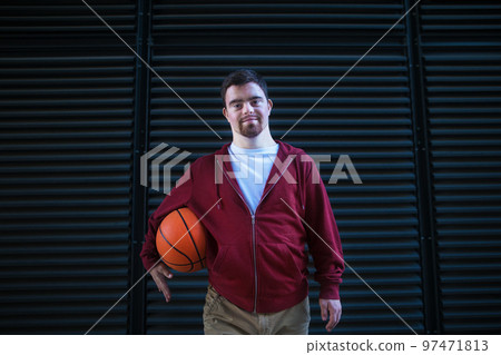 Portrait of young man with down syndrom holding basketball ball. Portrait of young man with down syndrom holding basketball ball. 97471813