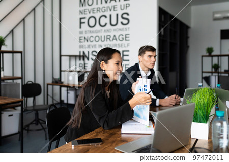 Business meeting. buiness team brainstorming while sitting at the office table together 97472011