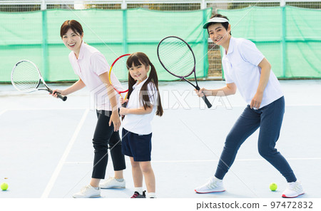 A woman enjoying tennis A woman enjoying tennis 97472832