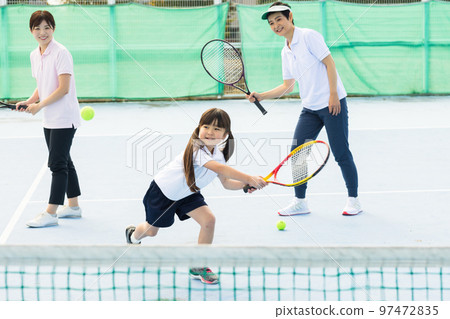 A woman enjoying tennis A woman enjoying tennis 97472835