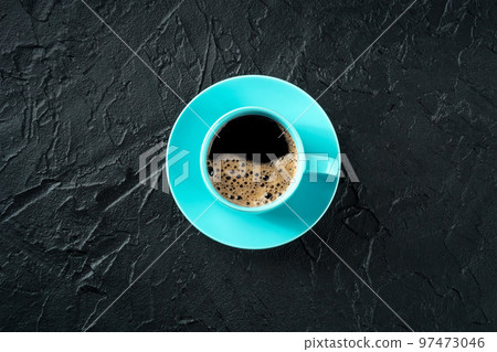 Coffee cup, overhead flat lay shot on a black slate background Coffee cup, overhead flat lay shot on a black slate background 97473046