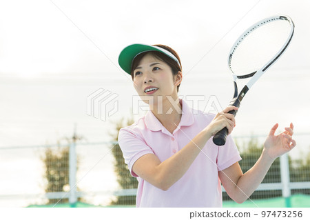 A woman enjoying tennis 97473256