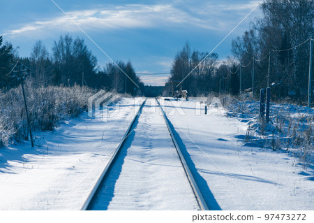 the railway tracks in winter go into the distance. around the forest 97473272
