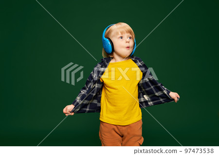 a young lady posing with headphones in blue background 31531688 Stock Photo  at Vecteezy