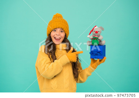 In shopping store. happy new 2020 year. rat symbol of year. small happy girl hold mouse. kid knitted sweater and hat play plush toy. toy shop for kids. christmas presents online. get ready for xmas 97473705