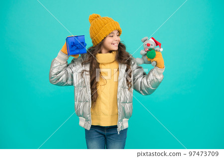 Wrapping box. Wrapping gifts. Idea of wrapping. Receiving presents. Girl winter clothes hold gift box toy. Buy gifts. Profitable deals and seasonal discount. Winter shopping. Making surprise 97473709