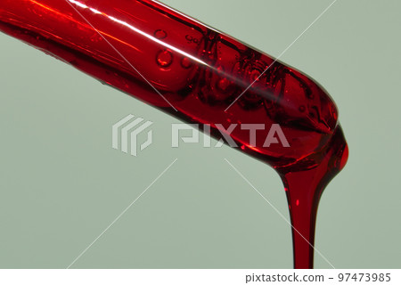 A drop of blood or other red liquid from a glass pipette. The concept of a blood test study with a copy space. High quality photo A drop of blood or other red liquid from a glass pipette. The concept of a blood test study with a copy space. High quality photo 97473985
