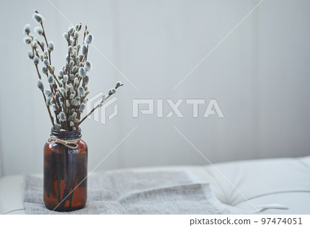 A bouquet of willow on the edge of the table. Willow, fluffy buds, brown glass vase. Happy Easter concept with copy space. High quality photo 97474051