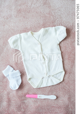 Newborn clothes and positive pregnancy test Newborn clothes and positive pregnancy test 97475065