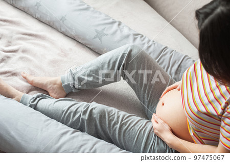 Young pregnant woman with maternity pillow is sleeping.. 97475067