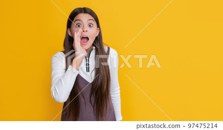 shocked girl with long hair on yellow background. hello 97475214