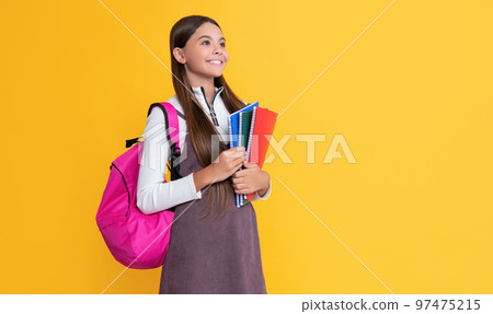 cheerful child with school backpack and workbook on yellow background cheerful child with school backpack and workbook on yellow background 97475215