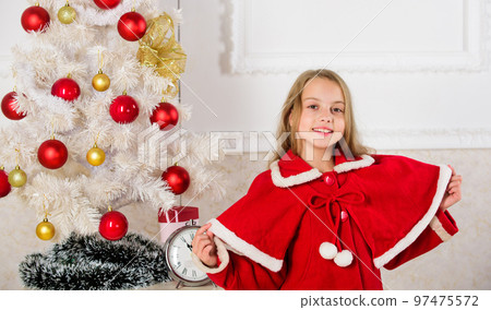 Childhood happiness concept. Child celebrate christmas at home. Favorite day of the year. Christmas celebration. Get incredibly excited about christmas. Kid girl festive costume near christmas tree Childhood happiness concept. Child celebrate christmas at home. Favorite day of the year. Christmas celebration. Get incredibly excited about christmas. Kid girl festive costume near christmas tree 97475572