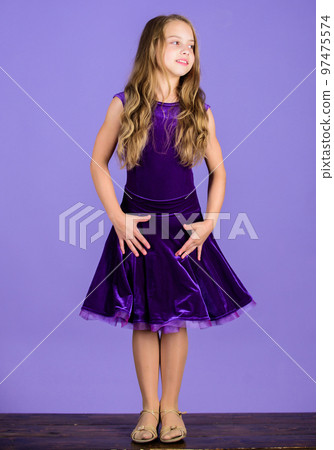 Kid fashionable dress looks adorable. Ballroom dancewear fashion concept. Kid dancer satisfied with concert outfit. Kids fashion. Girl cute child wear velvet violet dress. Clothes for ballroom dance 97475574