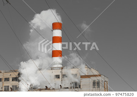 The pipe of the industrial plant emits toxic grey smoke into the atmosphere sky and air. Pollution of the environment and ecology. Thermal power plant The pipe of the industrial plant emits toxic grey smoke into the atmosphere sky and air. Pollution of the environment and ecology. Thermal power plant 97475820