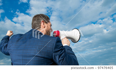 back view of businessman agitate in loudspeaker on sky background back view of businessman agitate in loudspeaker on sky background 97476405
