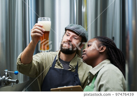 Brewery Workers Checking Beer Froth 97476439