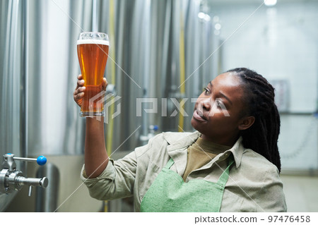 Worker Checking Beer Color Worker Checking Beer Color 97476458