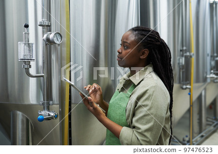 Brewery Worker Checking Pressure and Temperature 97476523