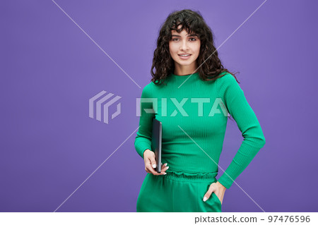 Young confident female employee or student in green casualwear Young confident female employee or student in green casualwear 97476596