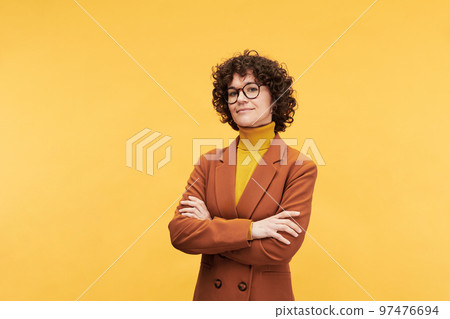 Young confident female teacher or manager crossing arms on chest Young confident female teacher or manager crossing arms on chest 97476694