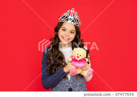 happy child in queen crown. princess in tiara. kid holding bear toy. teen girl wear diadem 97477059