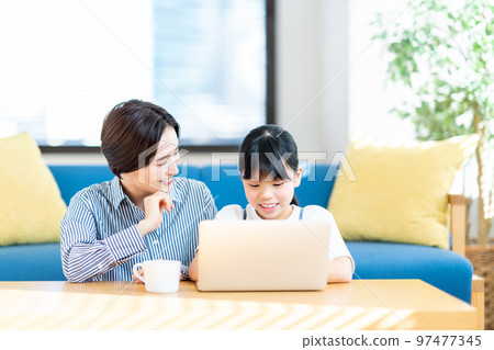 Girl learning programming in the living room Girl learning programming in the living room 97477345