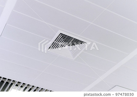 Ceiling mounted cassette type air conditioner and modern lamp light on white ceiling. duct air conditioner for home or office 97478030