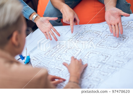 Group of draftspeople working on a drawing 97478620